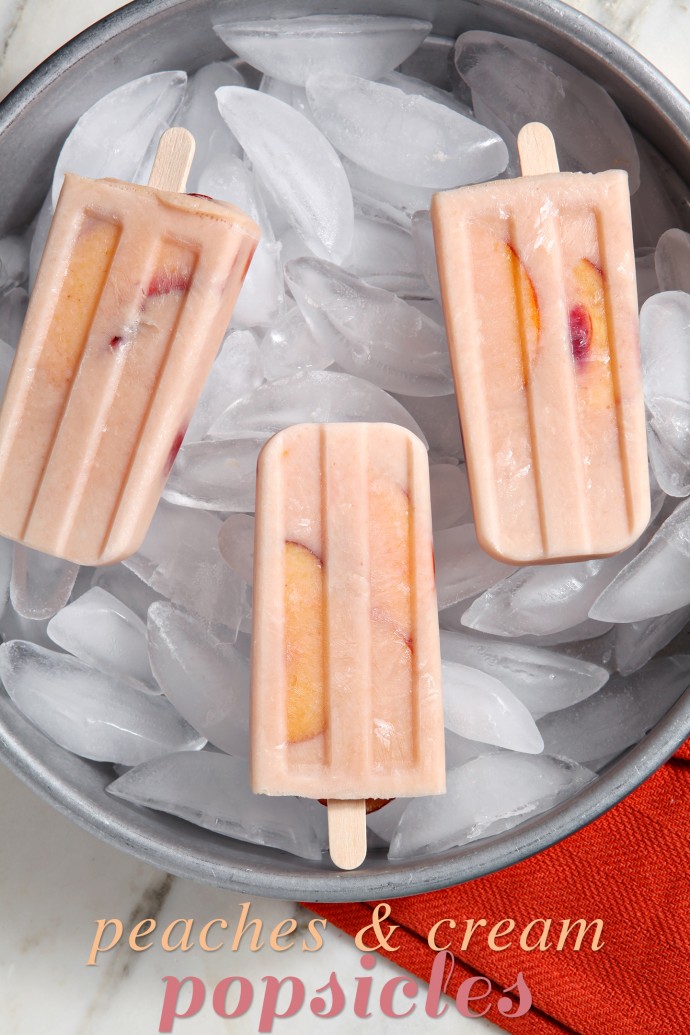 Cool down this August with slightly sweet and dreamy Peaches and Cream Popsicles! Sprinkle sliced peaches with sugar, letting them steep in the beautiful liquid. Strain the peaches and save the juices... then combine the juice with Greek yogurt and a few peaches to create these decadent popsicles!